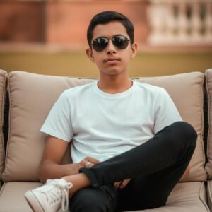 Confident Young Boy on Outdoor Lounge