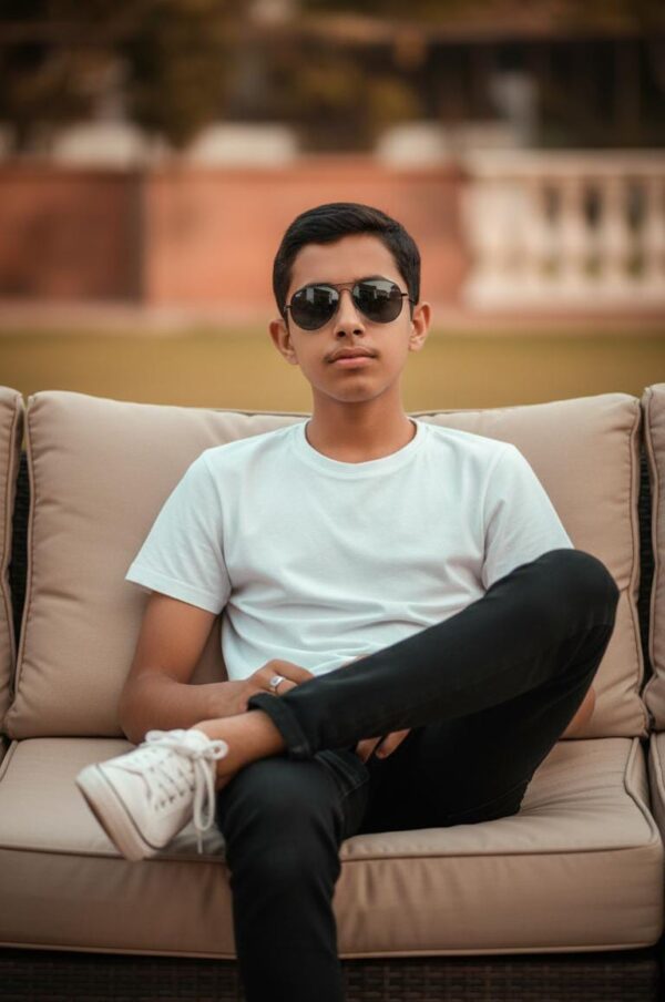 Confident Young Boy on Outdoor Lounge